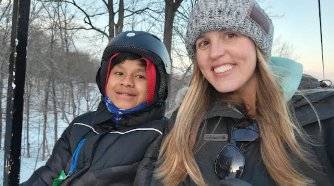 Jordyn and one of her kids on a ski lift